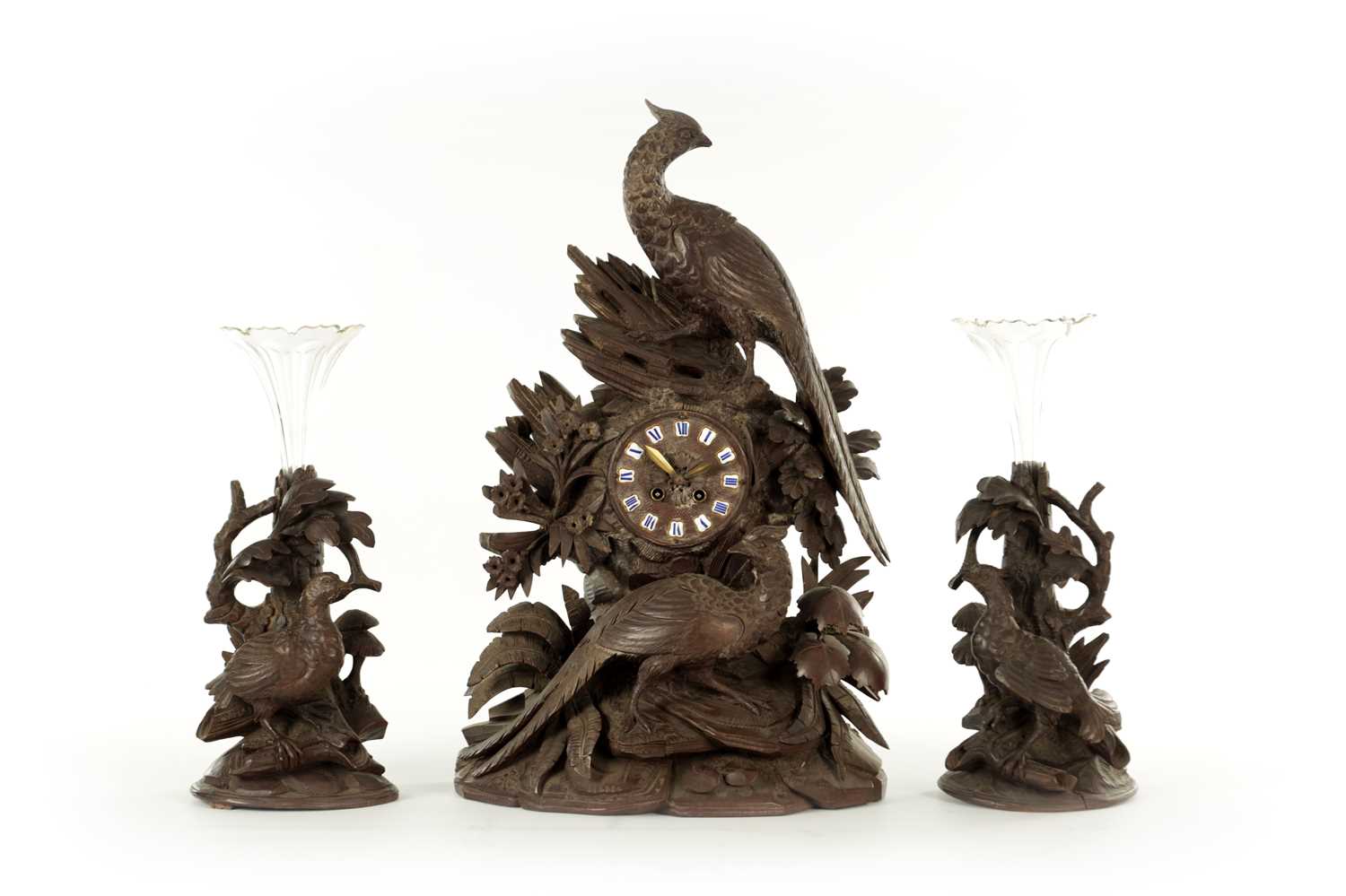 Lot 977 - A 19TH CENTURY BLACK FOREST CARVED THREE PIECE CLOCK GARNITURE