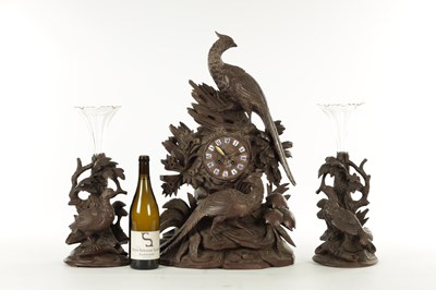 Lot 977 - A 19TH CENTURY BLACK FOREST CARVED THREE PIECE CLOCK GARNITURE