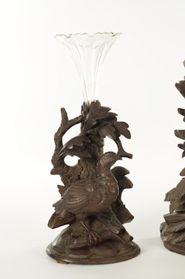 Lot 977 - A 19TH CENTURY BLACK FOREST CARVED THREE PIECE CLOCK GARNITURE