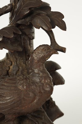 Lot 977 - A 19TH CENTURY BLACK FOREST CARVED THREE PIECE CLOCK GARNITURE