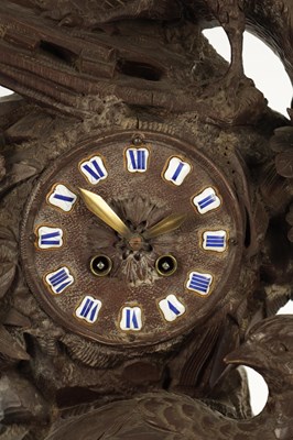 Lot 977 - A 19TH CENTURY BLACK FOREST CARVED THREE PIECE CLOCK GARNITURE