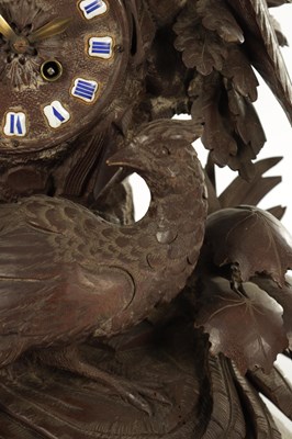 Lot 977 - A 19TH CENTURY BLACK FOREST CARVED THREE PIECE CLOCK GARNITURE