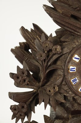 Lot 977 - A 19TH CENTURY BLACK FOREST CARVED THREE PIECE CLOCK GARNITURE