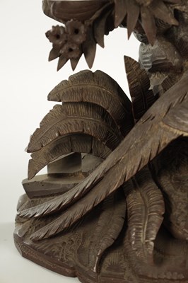 Lot 977 - A 19TH CENTURY BLACK FOREST CARVED THREE PIECE CLOCK GARNITURE