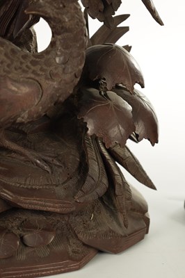 Lot 977 - A 19TH CENTURY BLACK FOREST CARVED THREE PIECE CLOCK GARNITURE