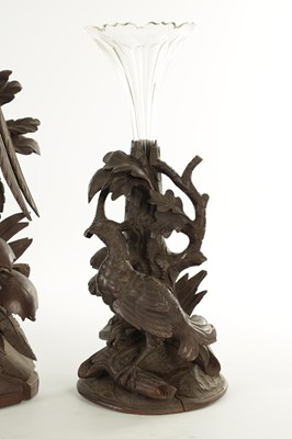 Lot 977 - A 19TH CENTURY BLACK FOREST CARVED THREE PIECE CLOCK GARNITURE