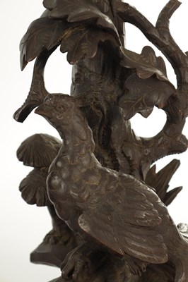 Lot 977 - A 19TH CENTURY BLACK FOREST CARVED THREE PIECE CLOCK GARNITURE