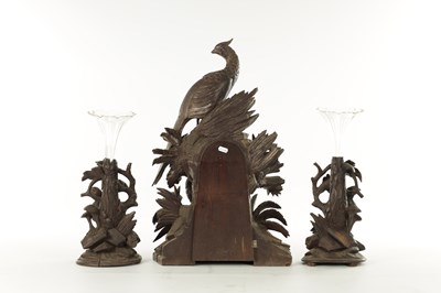 Lot 977 - A 19TH CENTURY BLACK FOREST CARVED THREE PIECE CLOCK GARNITURE