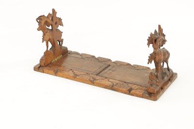Lot 745 - A 19TH CENTURY CARVED LINDEN WOOD BLACK FOREST ADJUSTABLE BOOK REST