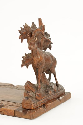 Lot 745 - A 19TH CENTURY CARVED LINDEN WOOD BLACK FOREST ADJUSTABLE BOOK REST
