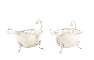Lot A PAIR OF MID 20TH CENTURY SILVER CREAM JUGS