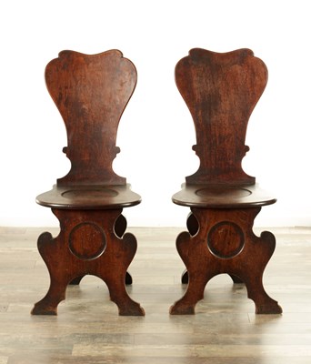 Lot A PAIR OF GEORGE II MAHOGANY HALL CHAIRS