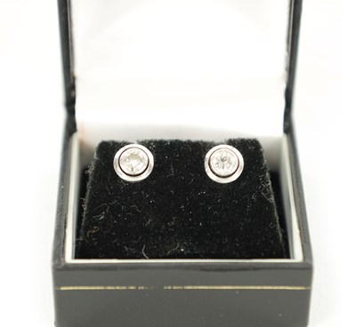 Lot A PAIR OF LADY'S PLATINUM SOLITAIRE DIAMOND EARRINGS