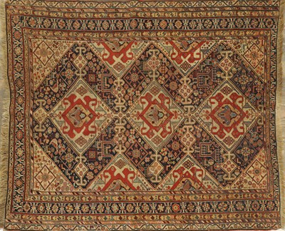 Lot AN ANTIQUE TRIBAL QASHQAI RUG