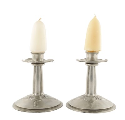 Lot A PAIR OF EARLY 20TH CENTURY TUDRIC PEWTER CANDLESTICKS IN THE MANNER OF ARCHIBALD KNOX