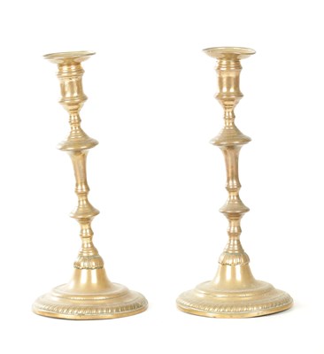 Lot A GOOD PAIR OF 18TH CENTURY BRASS SEAMED CANDLESTICKS