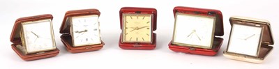 Lot 133 - A SELECTION OF FIVE LEATHER CASED TRAVEL CLOCKS