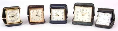 Lot 134 - A SELECTION OF FIVE LEATHER CASED TRAVEL CLOCKS