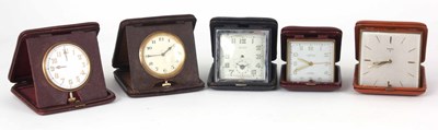 Lot 135 - A SELECTION OF FIVE LEATHER CASED TRAVEL CLOCKS