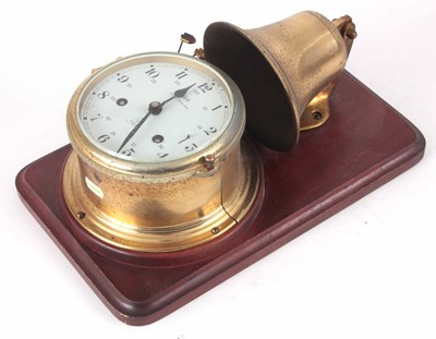 Lot 188 - A BRASS SHIPS CLOCK STRIKING ON A BELL mounted...