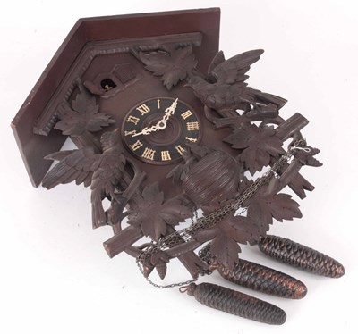 Lot 196 - A CARVED BLACK FOREST CARVED CUCKOO CLOCK WITH...