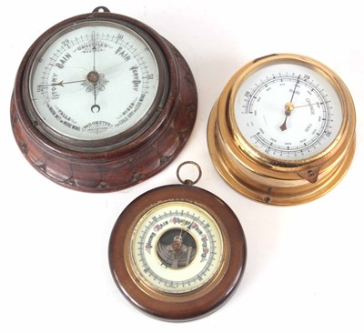 Lot 205 - THREE ANEROID BAROMETERS one brass cased ships...