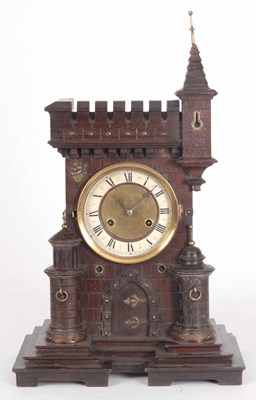 Lot 386 - A BLACK FOREST CARVED OAK CASTLE CASED MANTLE...