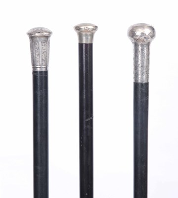 Lot 617 - THREE WALKING CANES having ebonised shafts,...