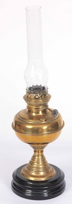 Lot 644 - A BRASS OIL LAMP WITH BLACK CERAMIC BASE AND...