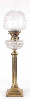 Lot 648 - A 19th CENTURY OIL LAMP ON A BRASS COLUMN BASE...