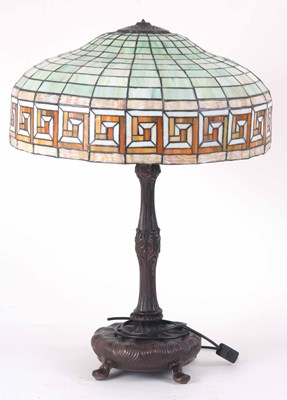 Lot 655 - A TIFFANY STYLE BRONZE BASE AND LEADED GLASS...