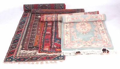 Lot 706 - FOUR RUGS one eastern runner with red ground...