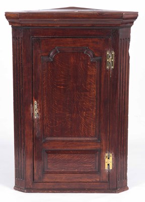 Lot 812 - A GEO III OAK HANGING CORNER CUPBOARD with...