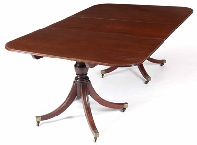 Lot 879 - A GEORGE III MAHOGANY TWIN PILLAR DINING TABLE...