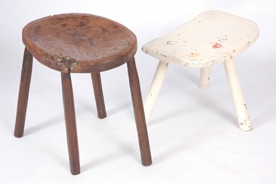 Lot 902 - TWO PRIMITIVE MILKING STOOLS one painted white...