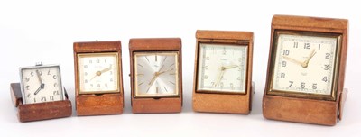 Lot 96 - A SELECTION OF FIVE LEATHER CASED TRAVEL CLOCKS