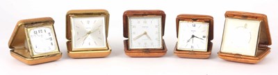 Lot 99 - A SELECTION OF FIVE LEATHER CASED TRAVEL CLOCKS