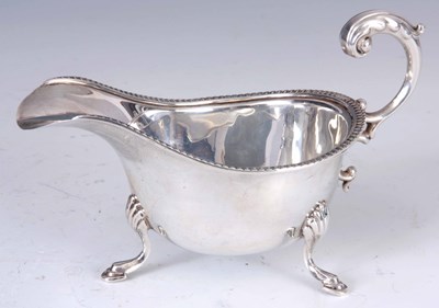 Lot 242 - A GEORGE VI SILVER SAUCE BOAT with scroll...