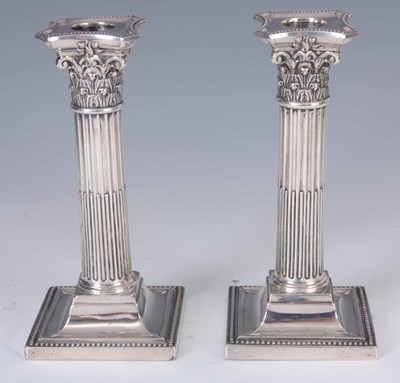 Lot 248 - A PAIR OF GEORGE V SILVER CORINTHIAN TOPPED...