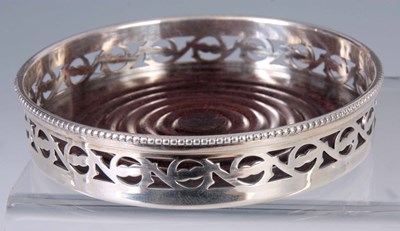 Lot 257 - A SILVER PLATED BOTTLE COASTER WITH OPEN-WORK...