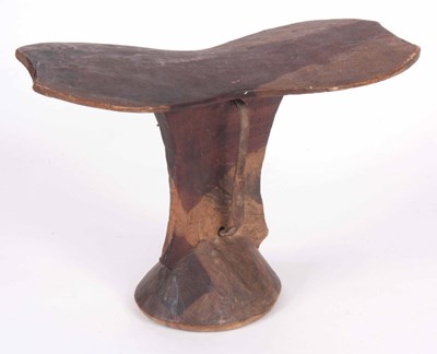 Lot 520 - A CARVED HARDWOOD AFRICAN HEADREST with side...