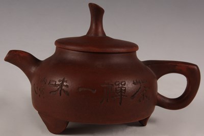 Lot 93 - An Oriental red glazed TEAPOT of shallow form...