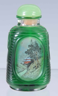 Lot 90 - A CHINESE GREEN GLASS CAMEO CUT SNUFF BOTTLE...