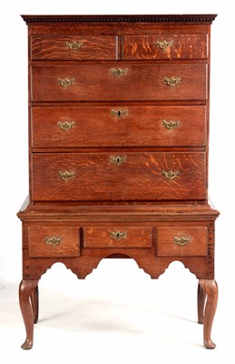 Lot 992 - A GEORGE III OAK CHEST ON STAND with moulded...