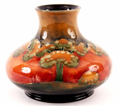 Lot 26 - A WILLIAM MOORCROFT SQUAT BULBOUS CABINET VASE...