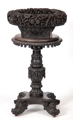 Lot 1014 - A 19TH CENTURY ANGLO INDIAN CARVED EBONY PLANT...