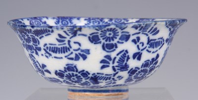 Lot 104 - A CHINESE BLUE AND WHITE RICE BOWL with flower...