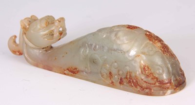 Lot 156 - A CHINESE CARVED RUST JADE BELT BUCKLE formed...