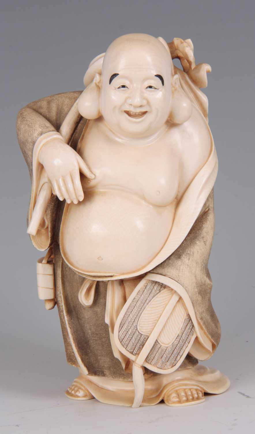 Lot 194 - A MEIJI PERIOD JAPANESE IVORY OKIMONO OF HOTEI...