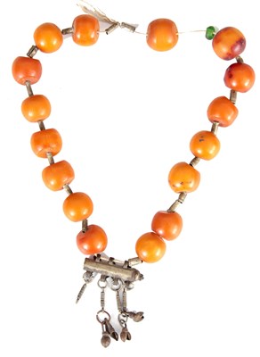 Lot 448 - A STRING OF AFRICAN AMBER BEADS butterscotch...